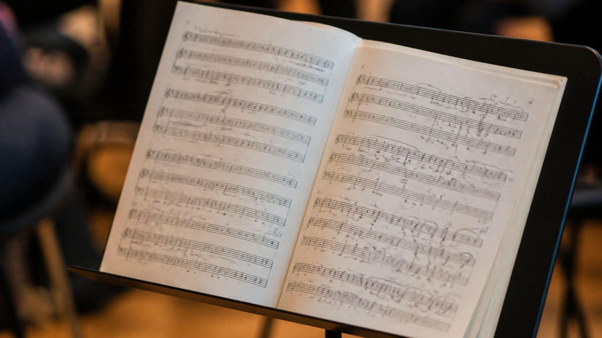 Partitions musicales ouvertes sur pupitre avec notes annotees