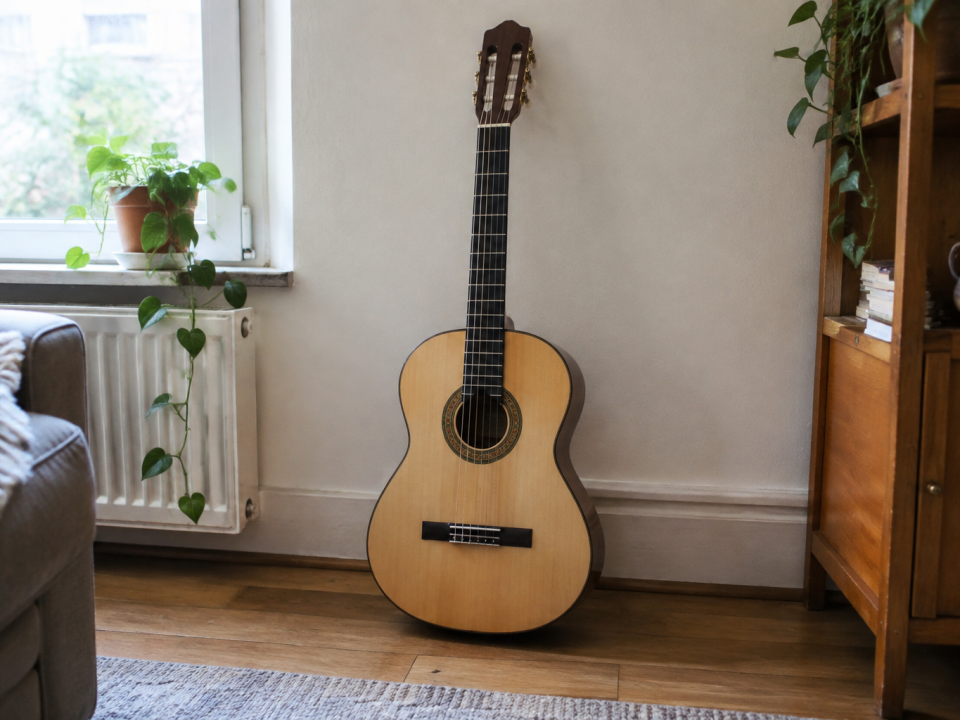 Guitare acoustique classique bois clair posée verticalement
